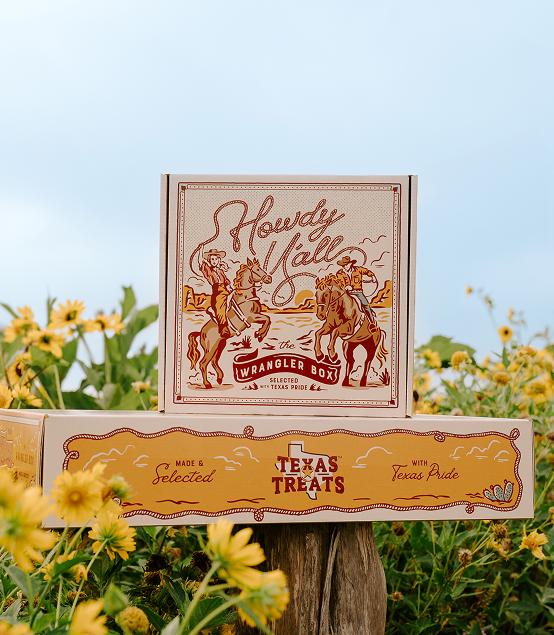 image of stacked Texas Treats gift boxes on a log