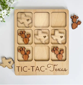 Wooden, Texas-themed tic tac toe board with pieces shaped like Texas and cacti.