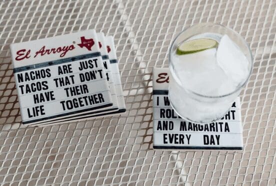 El Arroyo coasters with a margarita sitting on top of one.